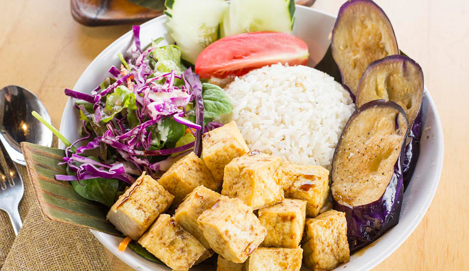 Tofu, eggplant, rice and chopped veggies in white bowl.