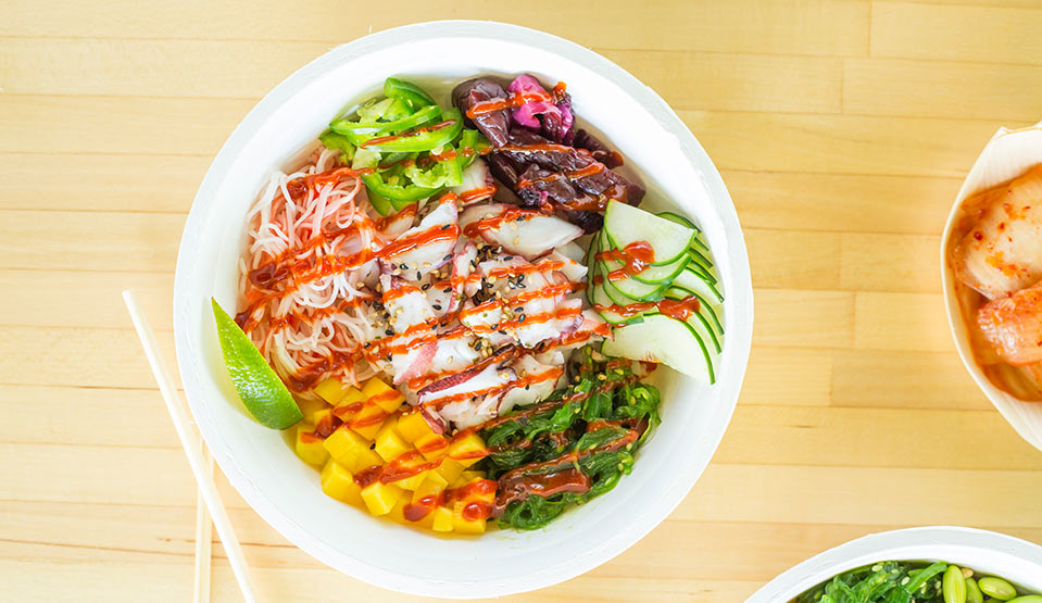 Colorful poke bowl with fresh veggies.