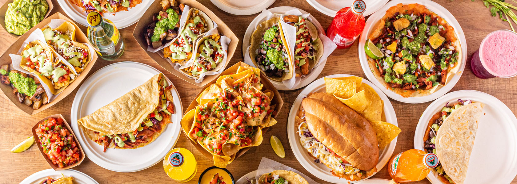 Bird's eye view of array of dishes served at Tacos Rudos
