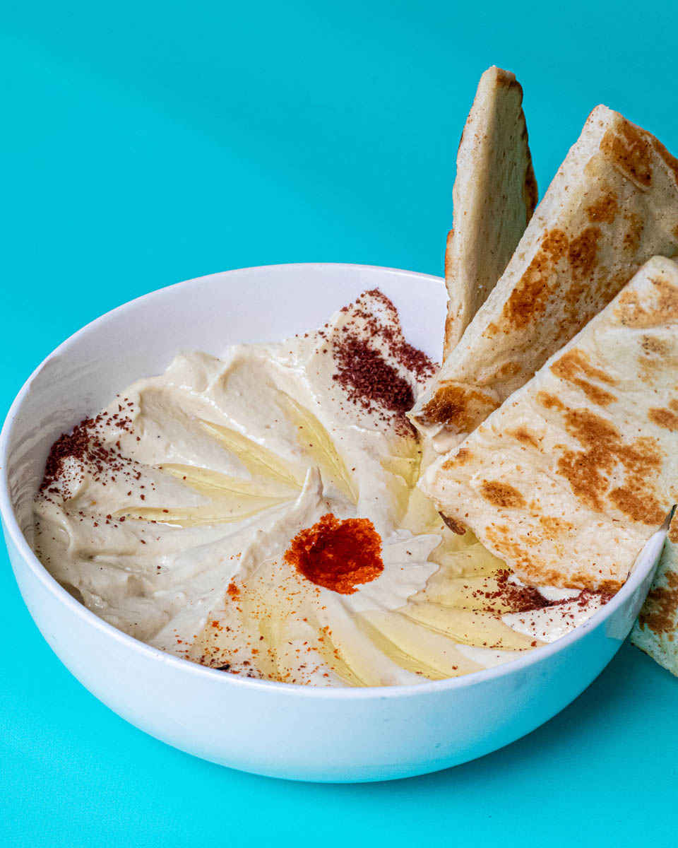 Hummus with pita triangles served by Zaki Mediterranean Grill at Budd Dairy Food Hall