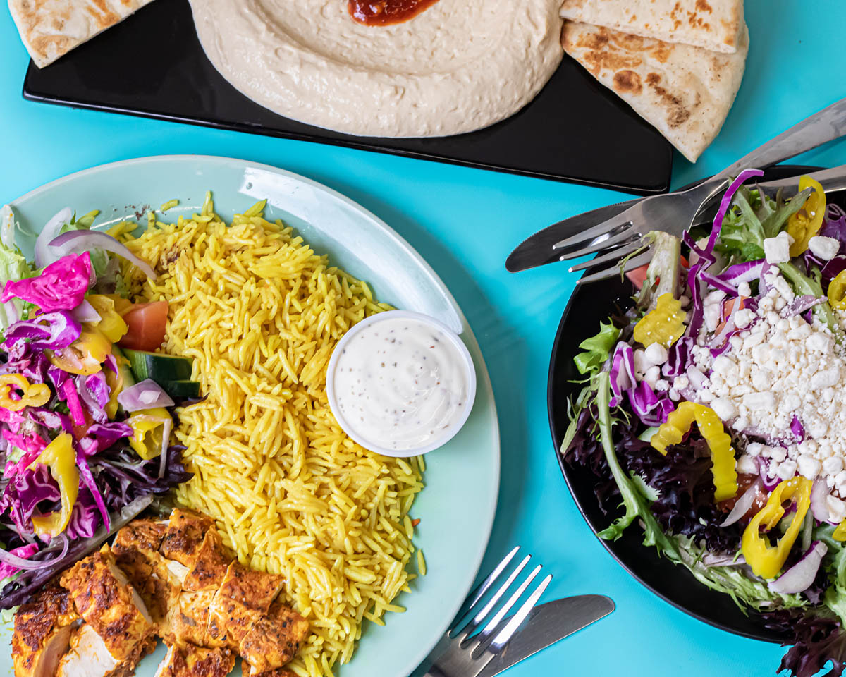 Two colorful plates of food showing rice, vegetables and chicken served at Zaki Mediterranean Grill at Budd Dairy Food Hall