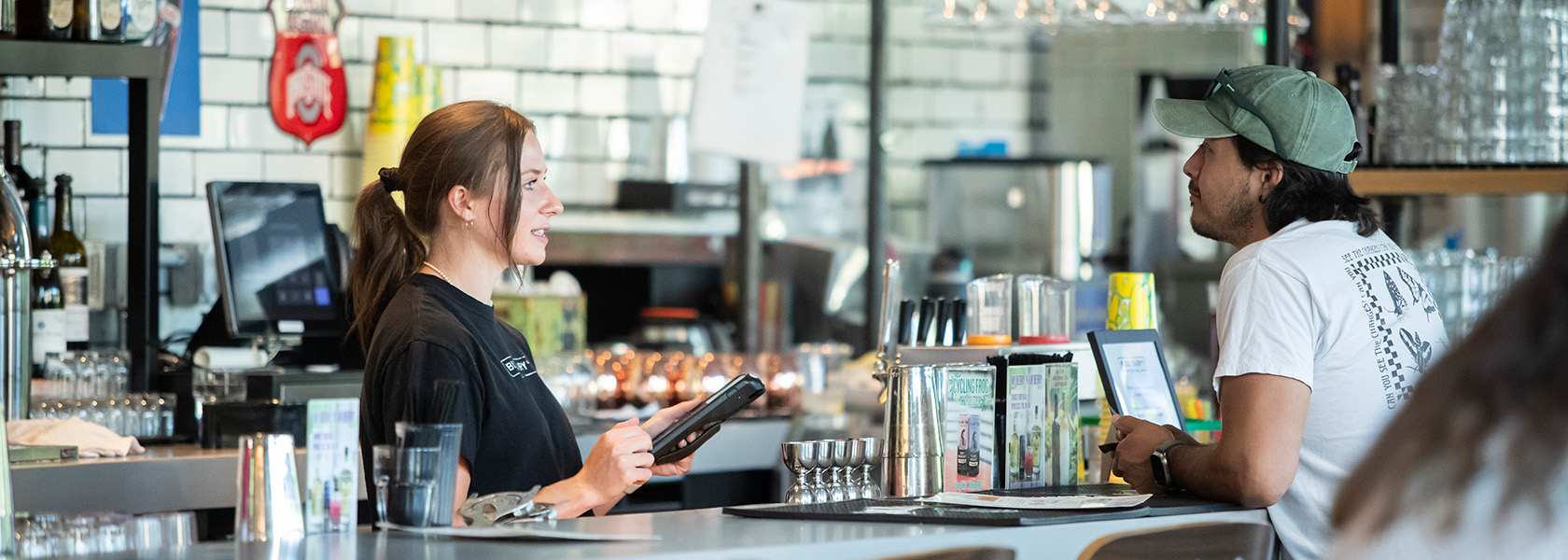 A Budd Dairy Food Hall bartender taking a customer's order